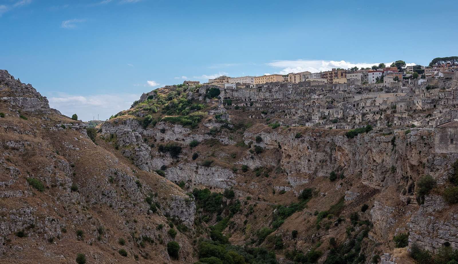 Stone cave houses of the Sassi di Matera in Basilicata, stacked on a rocky slope.